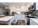 Bright kitchen boasts white cabinets, stainless steel appliances, and quartz countertops at 3405 E 33Rd Ave, Tampa, FL 33610