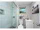 Modern bathroom with a walk-in shower, white vanity, and stylish decor at 3405 E 33Rd Ave, Tampa, FL 33610