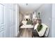 Green-toned bedroom with a cozy sitting area, natural light, and a view of the hallway at 3405 E 33Rd Ave, Tampa, FL 33610