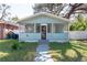 Charming light blue bungalow with a screened porch and well-maintained lawn at 3405 E 33Rd Ave, Tampa, FL 33610