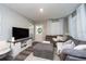 Bright living room with a sectional sofa and a modern entertainment center at 3405 E 33Rd Ave, Tampa, FL 33610