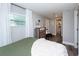 Charming bedroom with olive green bedding, dresser, and adjacent bathroom access at 3405 E 33Rd Ave, Tampa, FL 33610