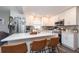 Updated kitchen featuring white cabinetry, stainless steel appliances, and an island with seating at 3405 E 33Rd Ave, Tampa, FL 33610