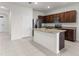 Open kitchen featuring granite countertops and dark wood cabinets at 1955 Hovenweep Rd, Wesley Chapel, FL 33543