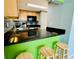 Kitchen breakfast bar with green backsplash and wooden stools at 724 Haven Pl, Tarpon Springs, FL 34689