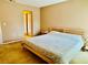 Main bedroom with mirrored closet doors and large bed at 724 Haven Pl, Tarpon Springs, FL 34689