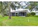 Private backyard with lush lawn and screened patio at 20920 Eustis Rd, Land O Lakes, FL 34637