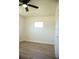 Bright bedroom with wood-look floors, ceiling fan and window at 4148 Fairford Dr, New Port Richey, FL 34652