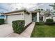 Single-story house with attached garage and teal door at 1439 Hickory Moss Pl, Trinity, FL 34655