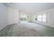 Living room with neutral carpeting and sliding glass doors at 1439 Hickory Moss Pl, Trinity, FL 34655