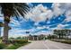 Gated entrance to a community with palm trees and landscaping at 1439 Hickory Moss Pl, Trinity, FL 34655