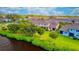 Aerial view of waterfront townhomes featuring lush green lawns and backyard patios overlooking a community lake at 2001 Palm Key Ave, Oldsmar, FL 34677