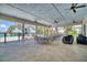 Covered patio area with tables and seating overlooking the pool and river at 2001 Palm Key Ave, Oldsmar, FL 34677