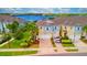 View of charming townhomes with colorful exteriors, landscaping, and water views in a waterfront community at 2001 Palm Key Ave, Oldsmar, FL 34677