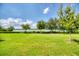 Scenic waterfront view with lush green lawn and trees at 2001 Palm Key Ave, Oldsmar, FL 34677