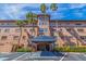 Exterior of the condo building with palm trees and covered entrance at 6100 Gulfport S Blvd # 316, Gulfport, FL 33707