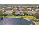 Aerial view of home with pool, screened lanai, and lake view at 7925 Royal Queensland Way, Lakewood Ranch, FL 34202