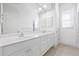 Elegant bathroom with double sinks, white cabinetry, and a large mirror for a spa-like experience at 7925 Royal Queensland Way, Lakewood Ranch, FL 34202