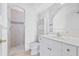 Bright bathroom with white cabinetry, tiled shower, and modern fixtures for a clean, updated feel at 7925 Royal Queensland Way, Lakewood Ranch, FL 34202