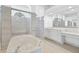 Bright, spacious bathroom with a soaking tub, tiled shower, and vanity at 7925 Royal Queensland Way, Lakewood Ranch, FL 34202