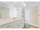 Bathroom with vanity, storage shelves, a walk-in shower, and neutral tile at 7925 Royal Queensland Way, Lakewood Ranch, FL 34202