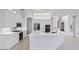 Bright, white kitchen with quartz countertops, modern appliances, and stylish pendant lighting at 7925 Royal Queensland Way, Lakewood Ranch, FL 34202