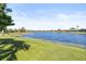 Scenic lake view showcasing lush greenery and calm waters, adding value to the property at 7925 Royal Queensland Way, Lakewood Ranch, FL 34202