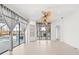 Sun-filled living room features tile floors, large windows with water views, and neutral decor at 7925 Royal Queensland Way, Lakewood Ranch, FL 34202