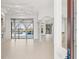 Bright living room boasts tiled flooring, decorative columns, and sliding doors to the pool at 7925 Royal Queensland Way, Lakewood Ranch, FL 34202