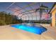 Stunning screened-in pool with spa overlooking the lake, perfect for relaxation and outdoor entertaining at 7925 Royal Queensland Way, Lakewood Ranch, FL 34202