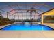 Stunning outdoor pool area with serene water views and lush tropical landscaping at 7925 Royal Queensland Way, Lakewood Ranch, FL 34202