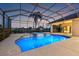 Inviting pool and spa with a screened enclosure overlooking a beautiful lake, perfect for leisure at 7925 Royal Queensland Way, Lakewood Ranch, FL 34202