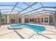 A large private pool and spa are surrounded by a screened-in enclosure and offer plenty of space at 7925 Royal Queensland Way, Lakewood Ranch, FL 34202
