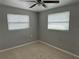 Well-lit bedroom with tile floors and two windows at 805 64Th N Ave, St Petersburg, FL 33702