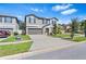 Two-story house with gray siding, landscaping, and a two-car garage at 12941 Wildflower Meadow Dr, Riverview, FL 33579