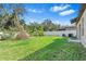 Grass backyard with some trees and AC units at 12941 Wildflower Meadow Dr, Riverview, FL 33579