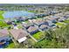 Community of two story houses with gray siding and landscaped yards near a lake at 12941 Wildflower Meadow Dr, Riverview, FL 33579