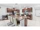 Eat-in kitchen with granite countertops and island seating at 12941 Wildflower Meadow Dr, Riverview, FL 33579