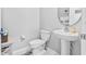 Clean and modern half bathroom with pedestal sink and toilet at 12941 Wildflower Meadow Dr, Riverview, FL 33579