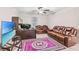 Home office with leather furniture and large TV at 12941 Wildflower Meadow Dr, Riverview, FL 33579