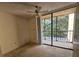 Bedroom with sliding glass doors to balcony and ceiling fan at 3076 Eastland Blvd # 209, Clearwater, FL 33761