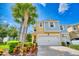 Two-story townhome with two-car garage and landscaping at 2001 Palm Key Ave, Oldsmar, FL 34677