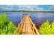 Wooden community dock extending over calm water at 2001 Palm Key Ave, Oldsmar, FL 34677