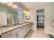 Elegant bathroom with granite countertops, double sinks, and a walk-in shower at 5521 Limelight Dr, Apollo Beach, FL 33572