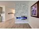 Modern electric fireplace with gray stone surround in living room at 5521 Limelight Dr, Apollo Beach, FL 33572