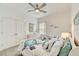 Guest bedroom with twin beds, dresser, and ceiling fan at 5521 Limelight Dr, Apollo Beach, FL 33572
