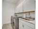 Laundry room with washer, dryer, sink, and cabinets at 5521 Limelight Dr, Apollo Beach, FL 33572