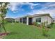 Spacious backyard with screened patio, lush lawn, and mature landscaping at 5521 Limelight Dr, Apollo Beach, FL 33572
