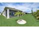 Landscaped backyard with screened porch and palm trees at 5521 Limelight Dr, Apollo Beach, FL 33572