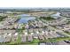 Aerial view of community with lake and numerous homes at 5521 Limelight Dr, Apollo Beach, FL 33572